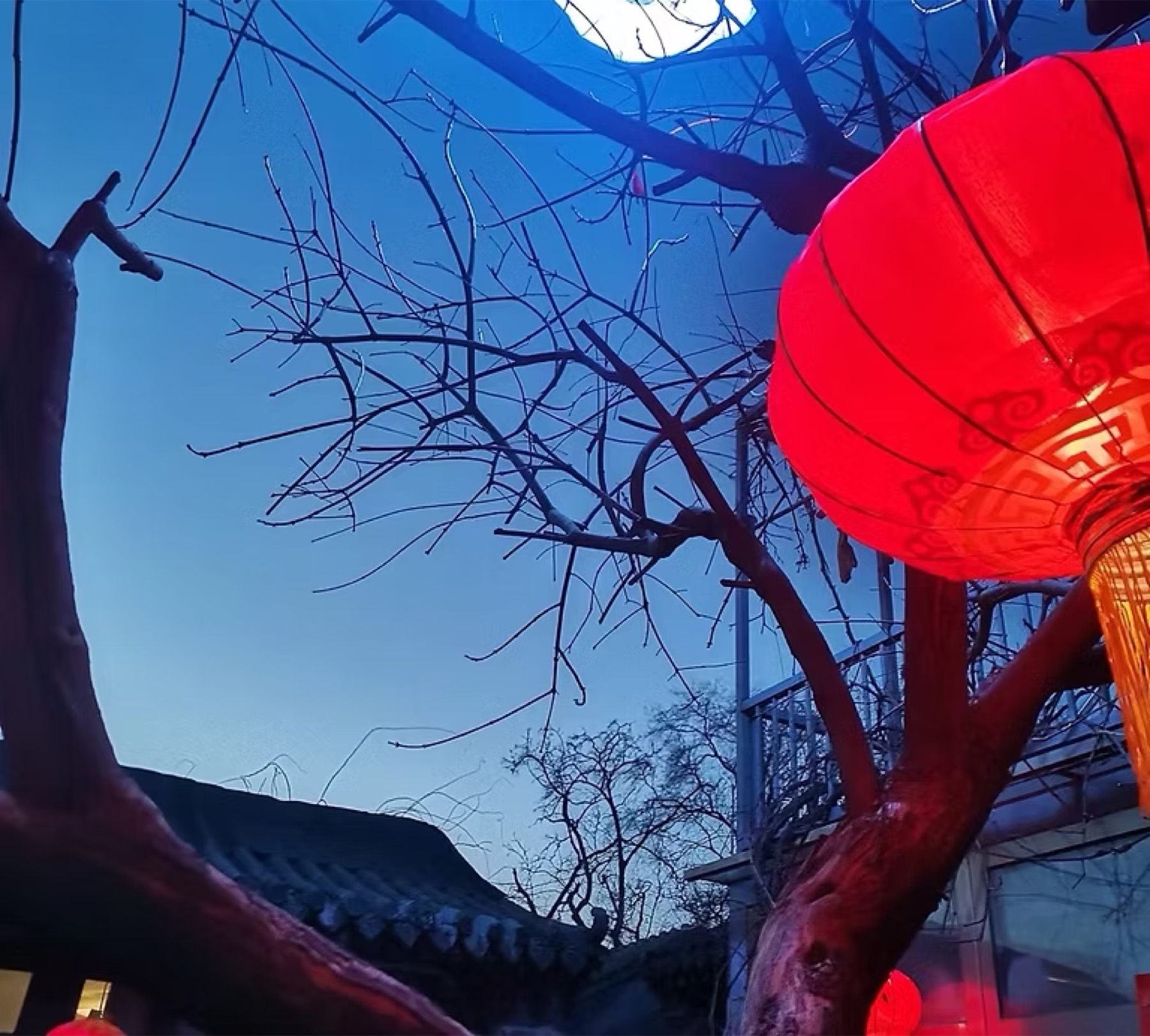 Red lanterns and tiled rooflines at Golden Silk Courtyard